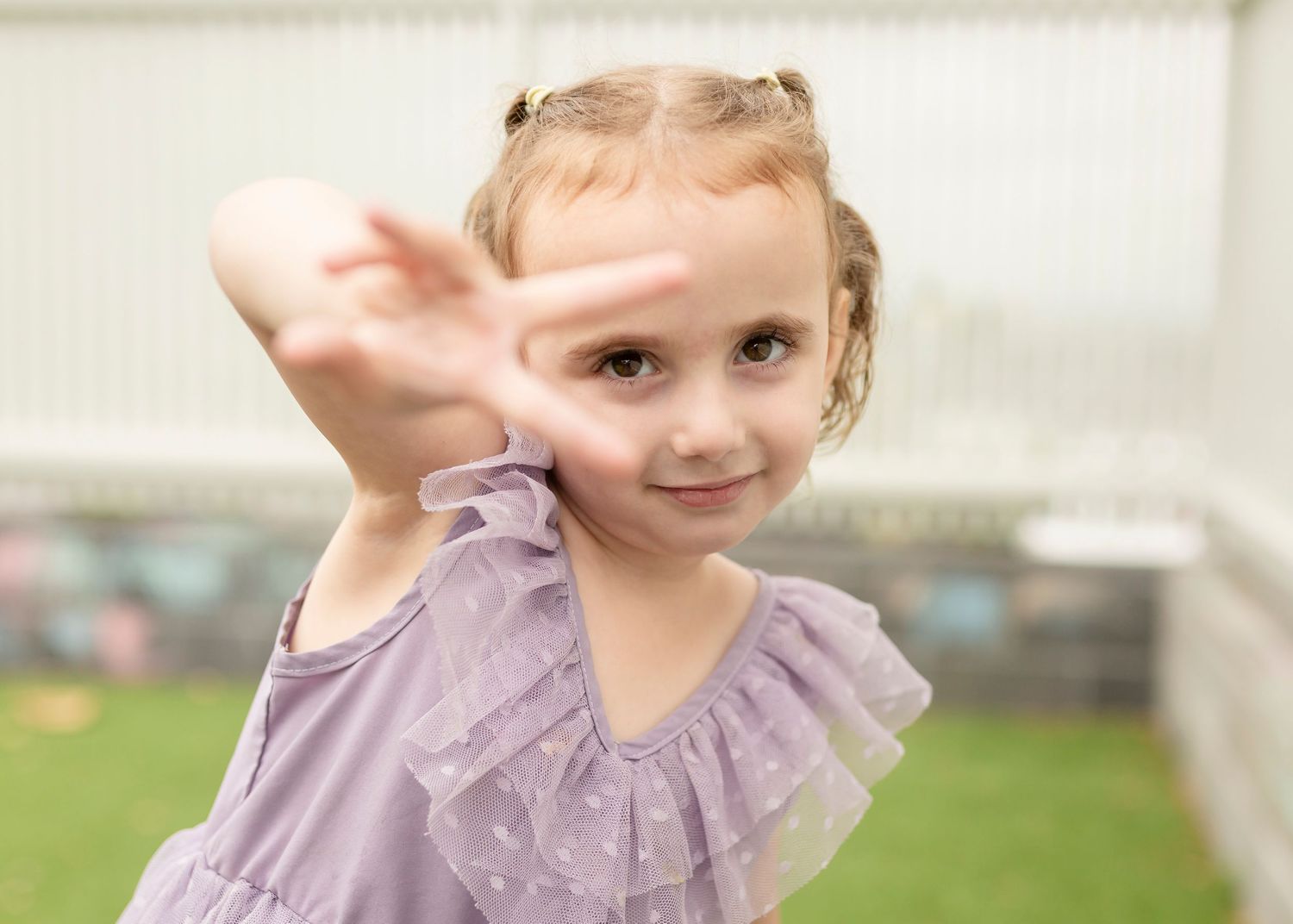 Play based Childcare/Daycare/Preschool photograph of a child captured having fun outdoors in their natural play environment