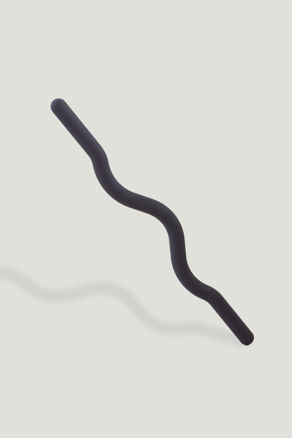 Black wavy strength beam  with ribbed texture on light gray background.