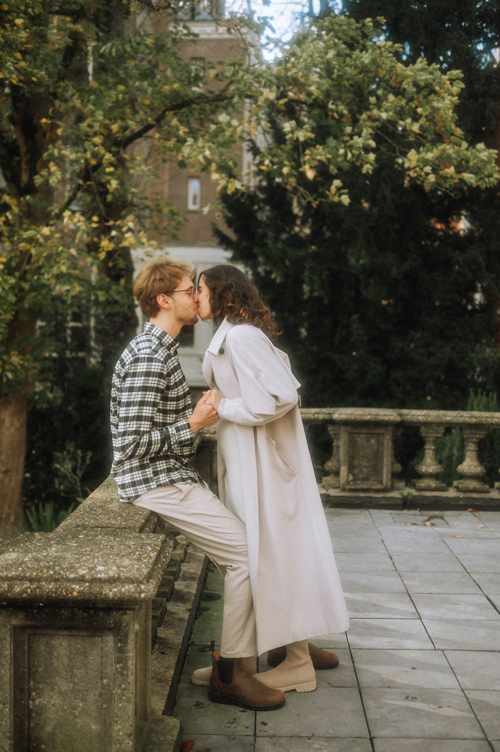 Sweet romantic moment on stone steps in a garden setting.