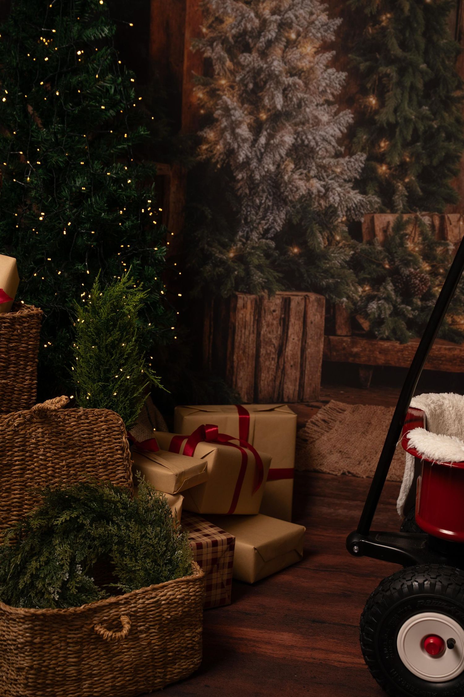 Cozy Christmas corner with rustic wicker basket, wrapped presents, and snow-dusted evergreen branches in warm lighting.