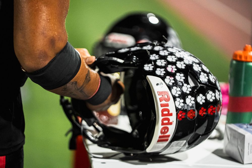 Football player grabbing his helmet
