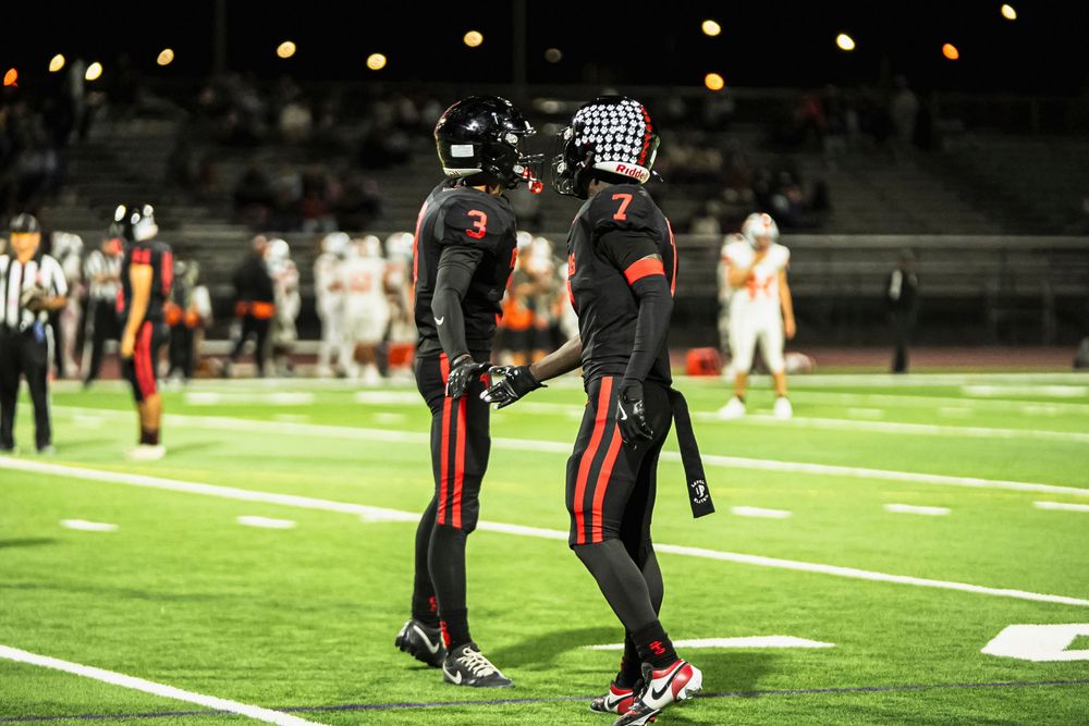 Football players high fiving