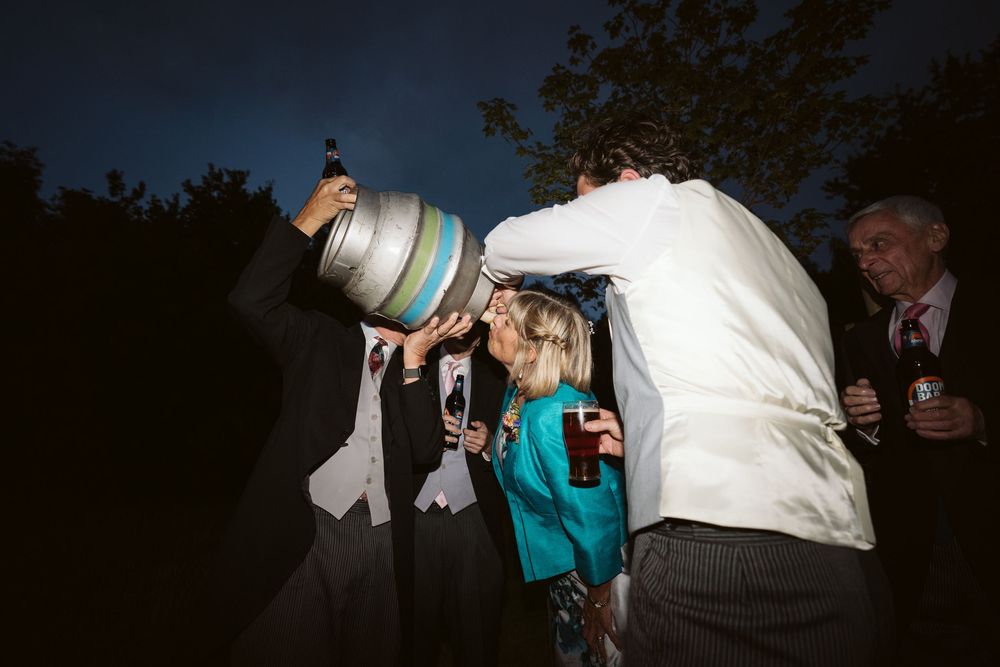 Surrey wedding evening reception with guests dancing and celebrating under string lights