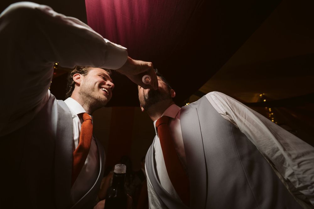 Bride and groom sharing a romantic dance under dramatic lighting at the Surrey wedding party