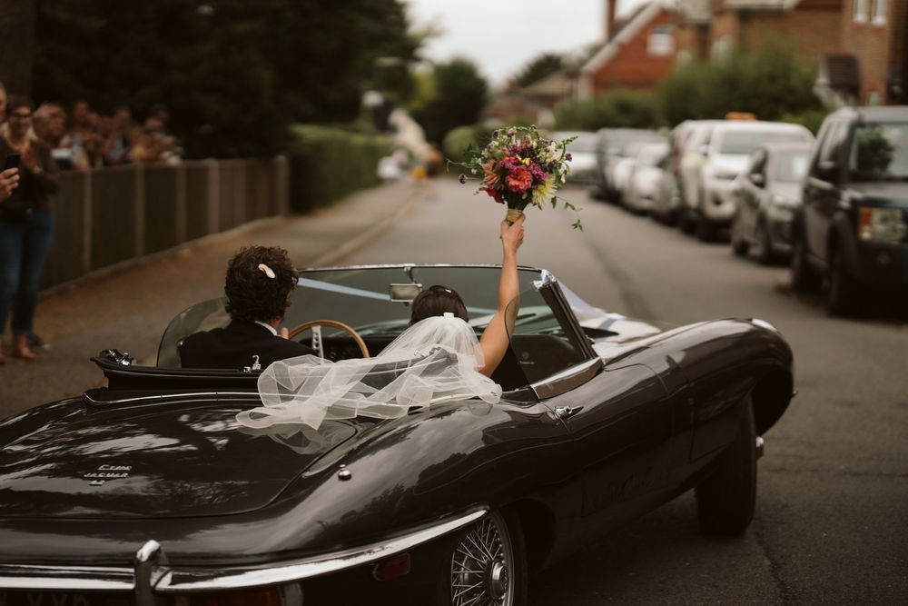 Classic vintage car arriving at the church for a Surrey wedding ceremony