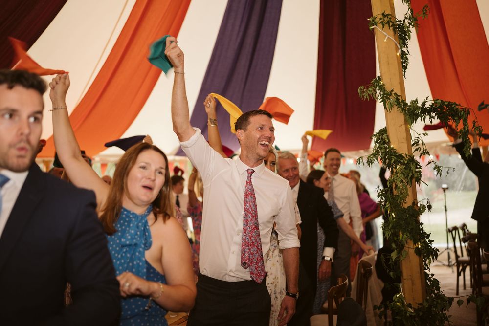Wedding party gathering near the marquee during a Surrey summer wedding