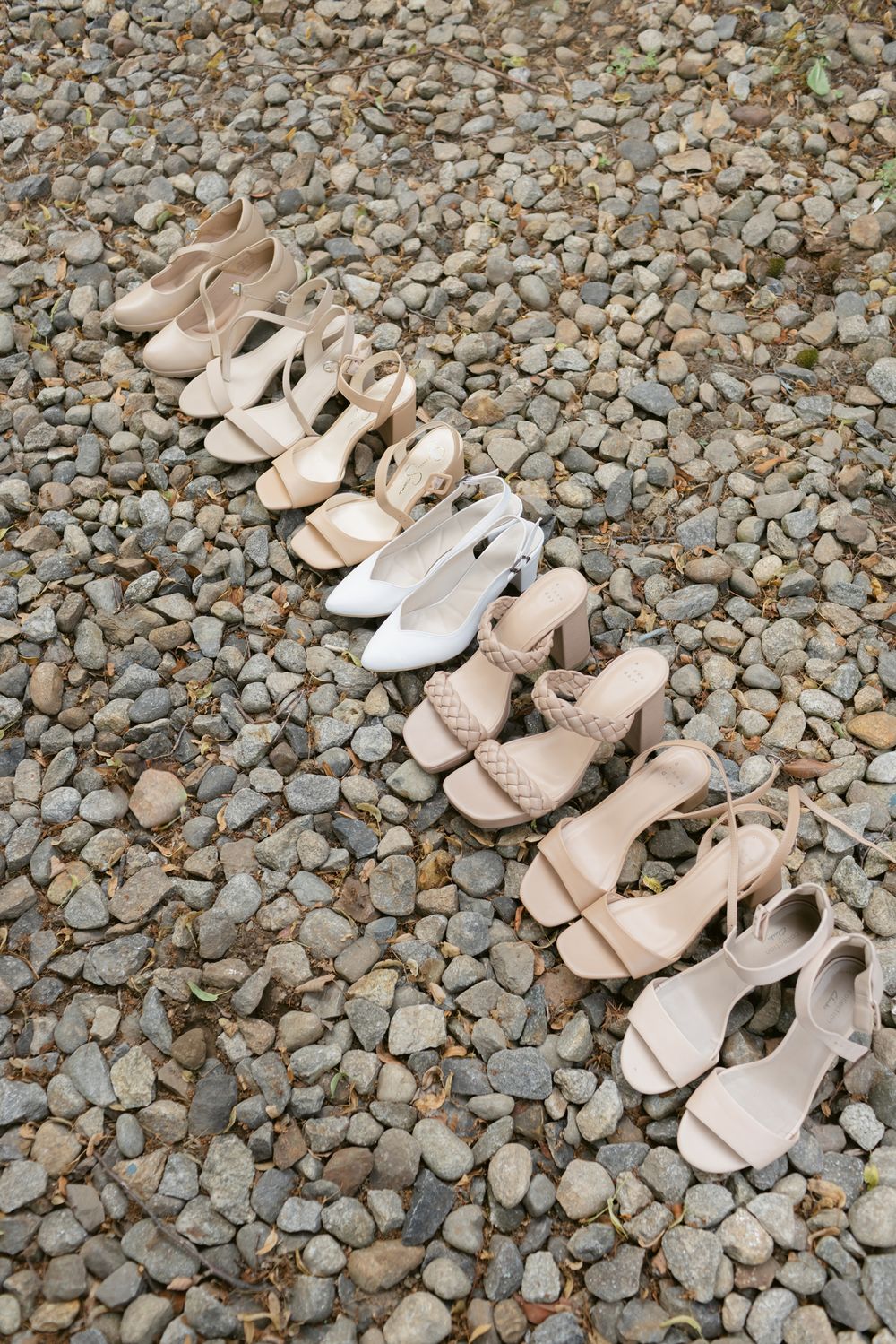 Neutral color bridal party shoes arranged on neutral rocks for wedding detail shots in Bradford, Massachusetts. Concord wedding photographer