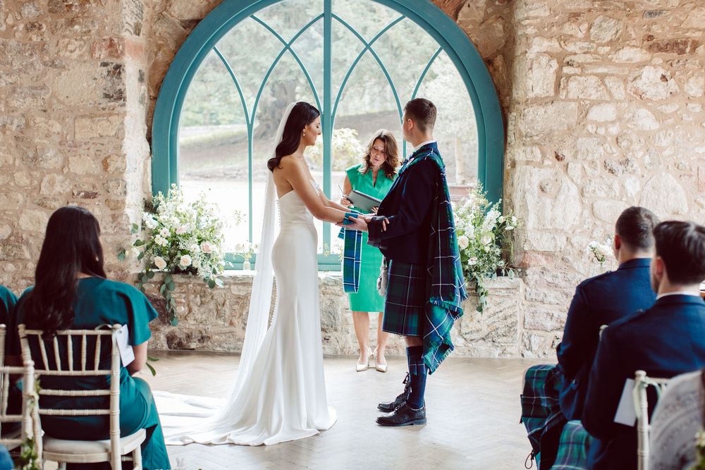 A series of wedding preparation photos showing a white dress against rustic stone walls with teal accents.