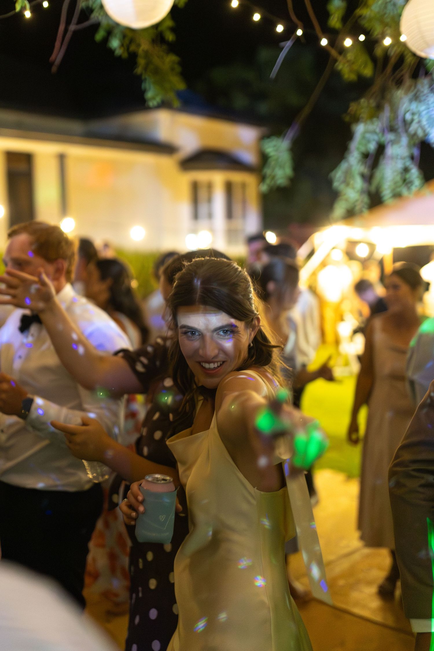 lady pointing at camera while dancing at country wedding