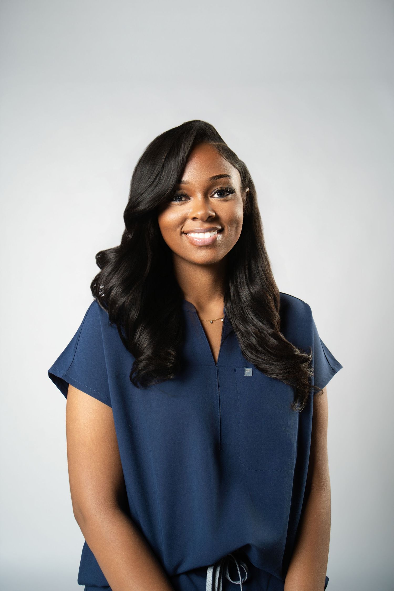 Professional headshot series showing someone in a navy blue blouse against a light background.