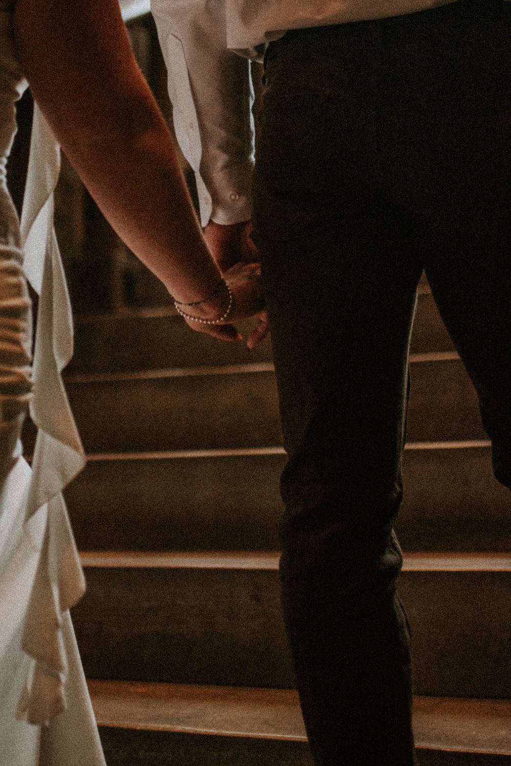Close up detail shot of the engaged couple holding hands as they walk up the stairs in Nashville, Tennessee.