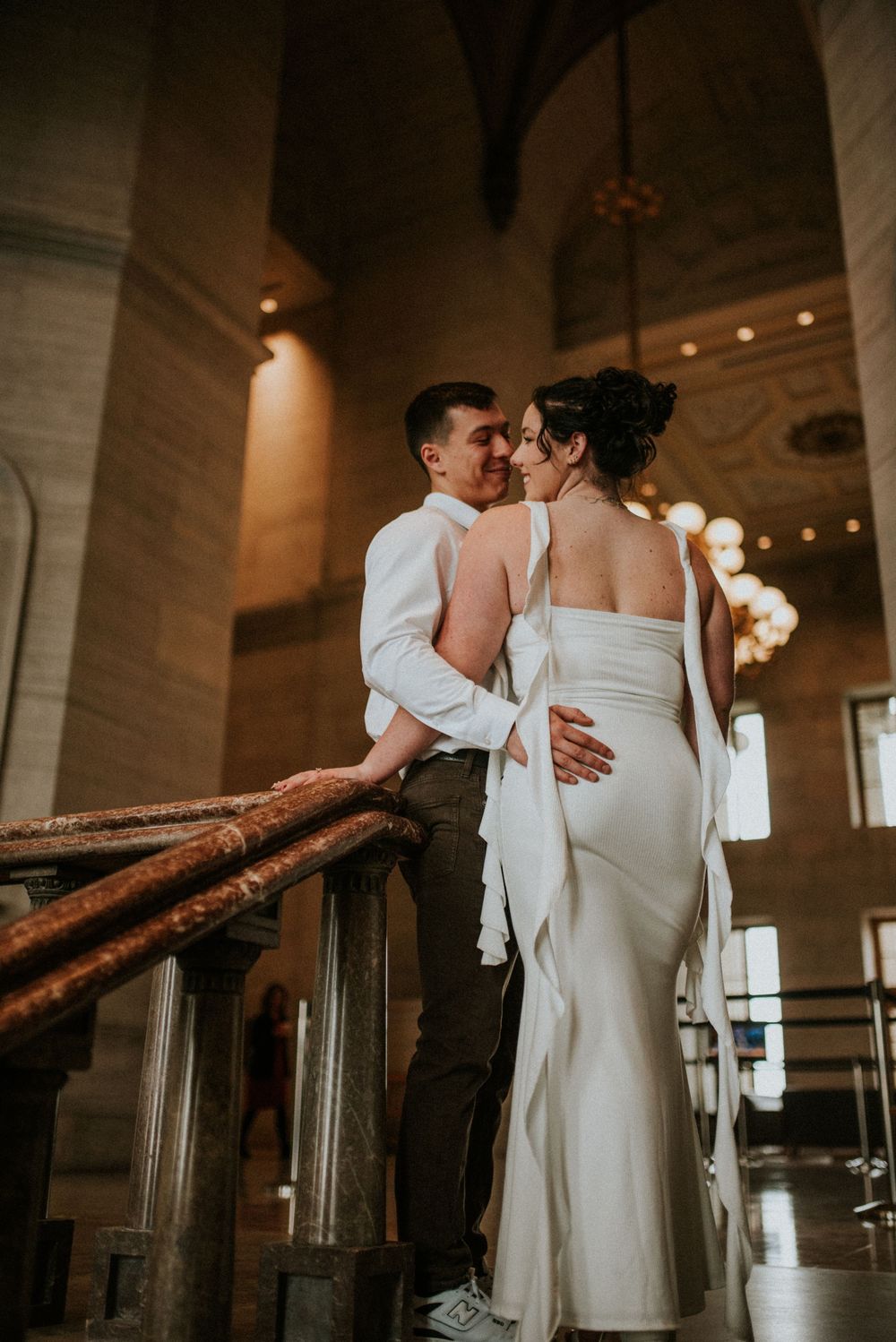 Engagement session with a fiancé holding his future wife on the top of the staircase in a historical building in Nashville, Tennessee.