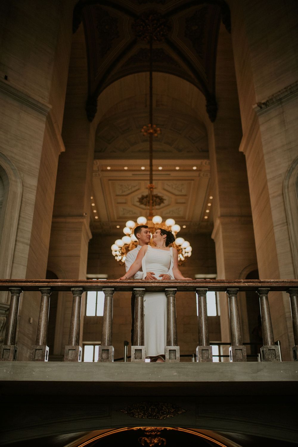 Engaged couple hugging on a floor above the affordable photographer in a historic building in Nashville, Tennessee.