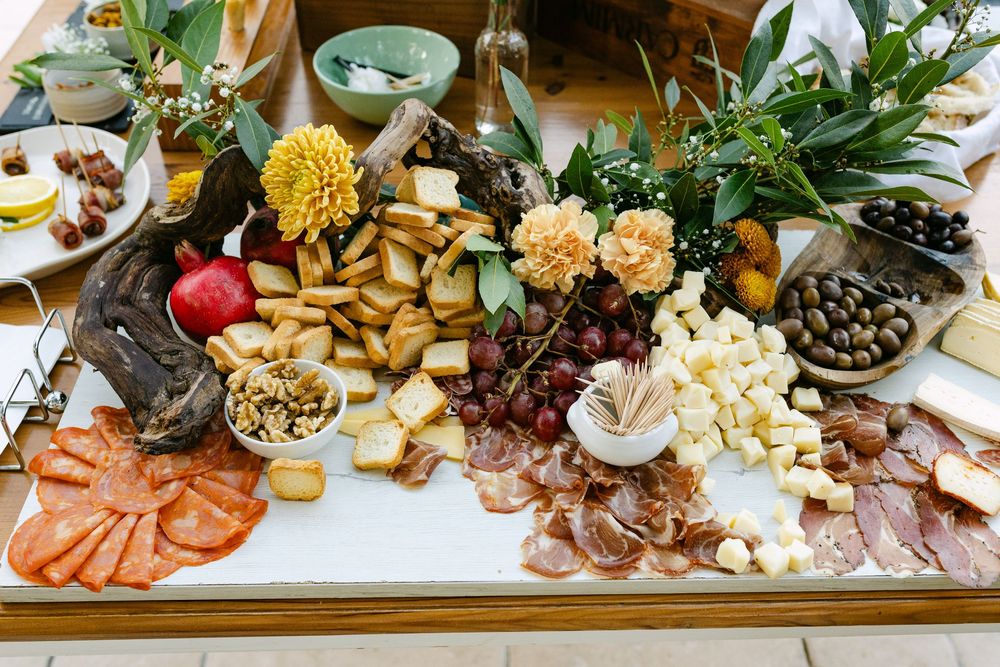 Wedding cocktail food table with charcuterie, cheese and fruits at destination wedding in Lisbon Portugal