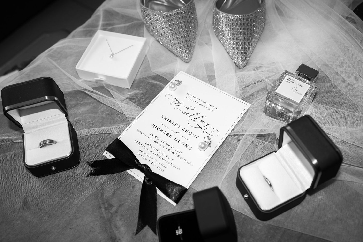 Black and white photo series showing engagement ring boxes, handwritten cards, and wedding details arranged on a surface.