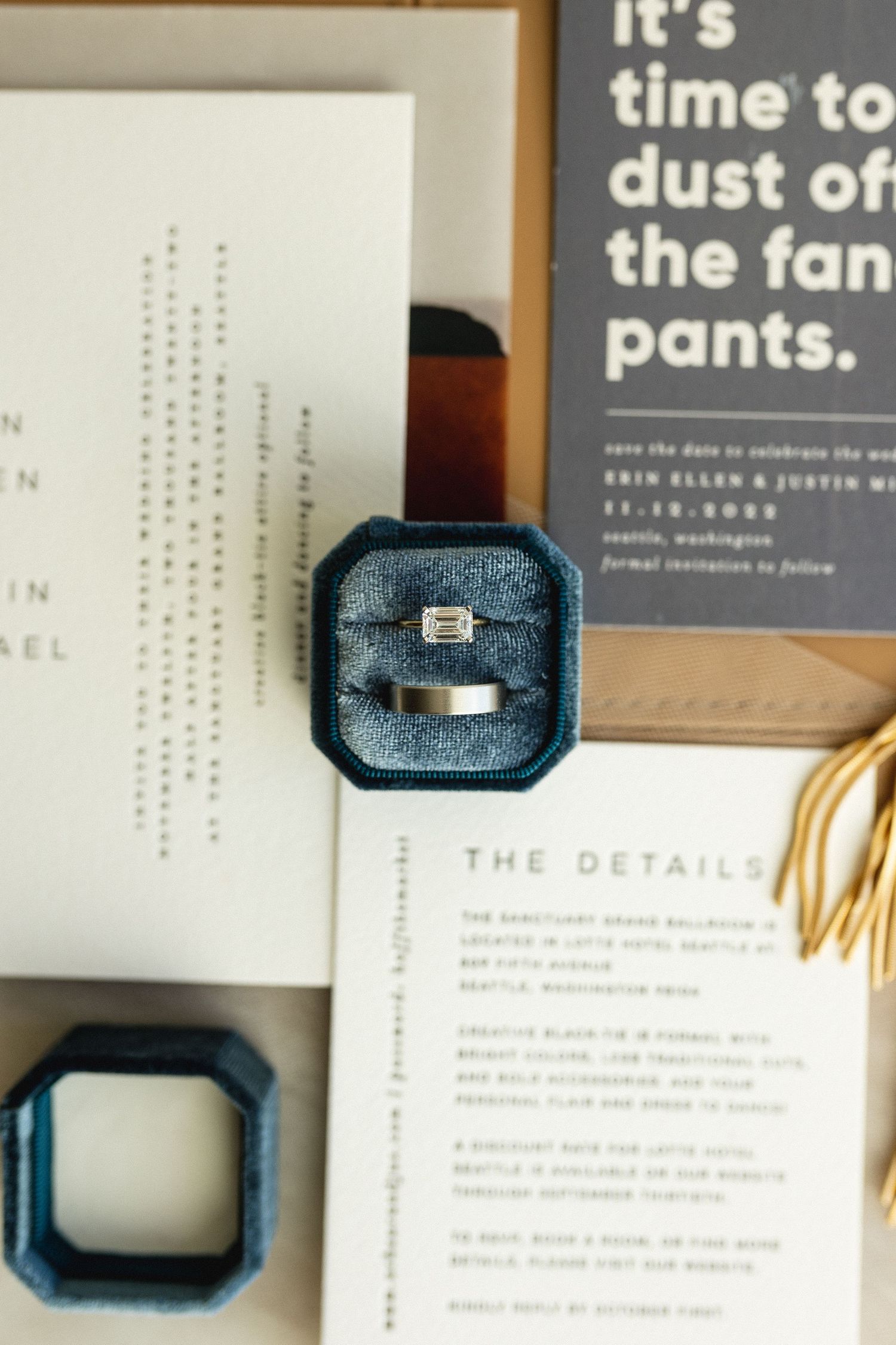 Diamond engagement ring in teal velvet box displayed on wedding stationery with bold typography save-the-date.