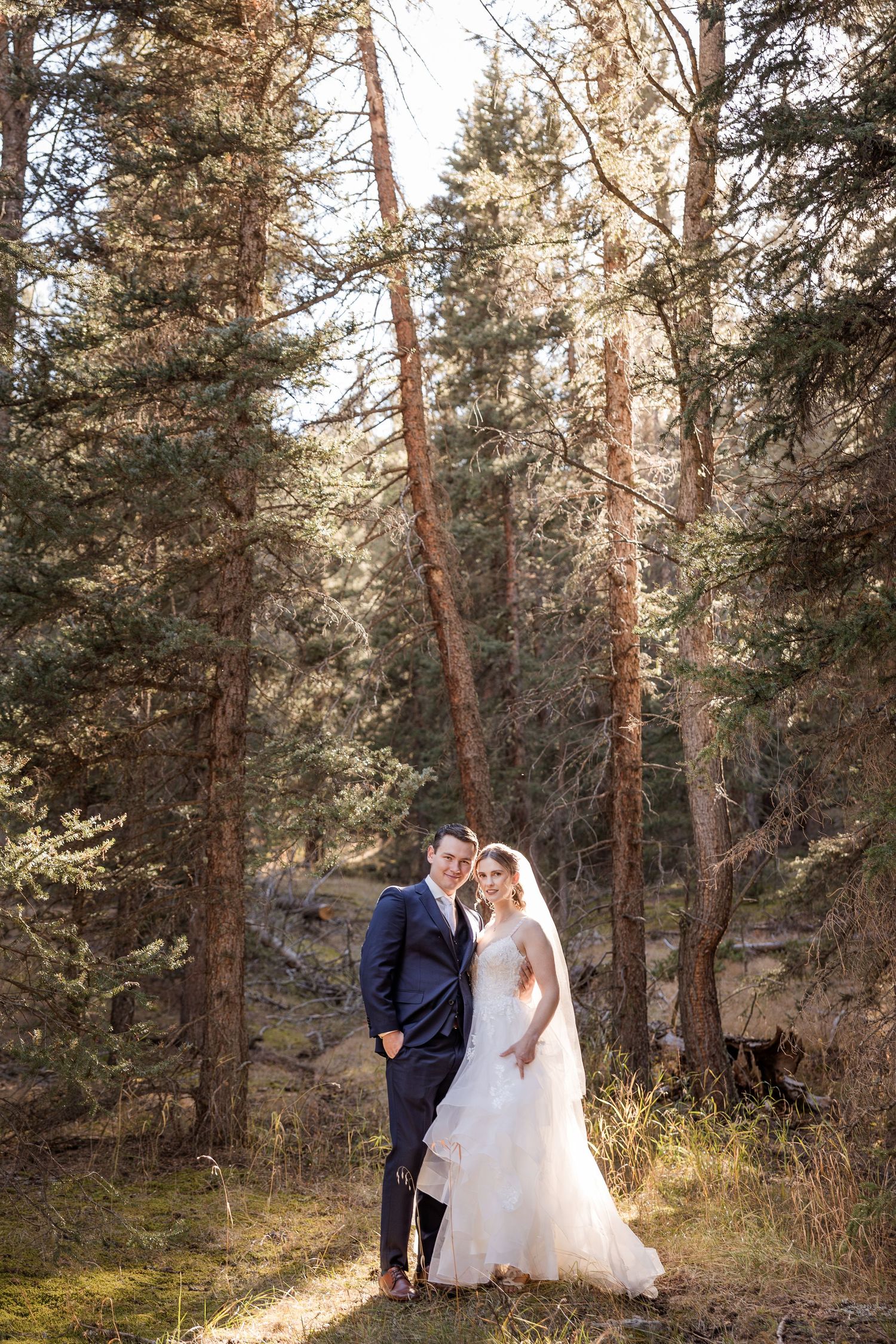 A dreamy wedding photo series showing a bride in a white ballgown twirling through a sunlit forest setting.