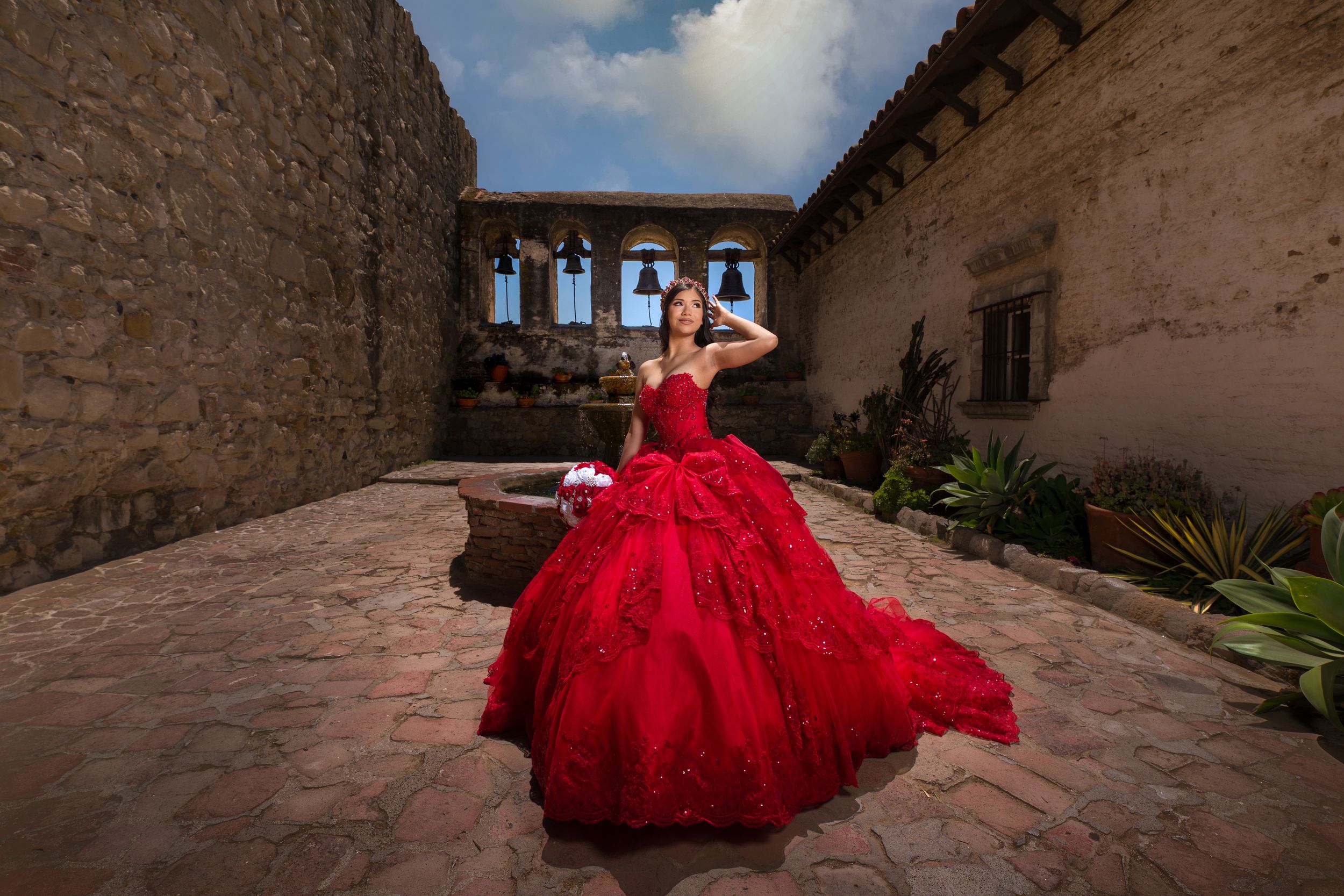 A person in a flowing red ball gown poses dramatically against rustic stone walls in multiple connected shots.