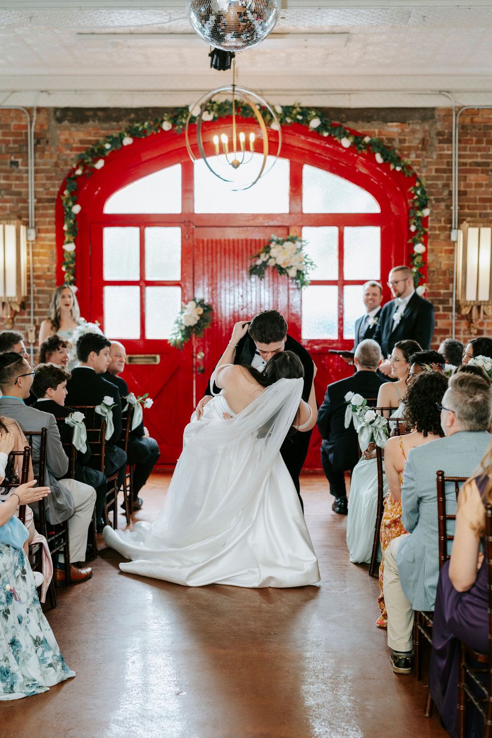 Sequence of wedding reception dance photos showing couple's first dance in a rustic brick venue with disco ball and red windows.