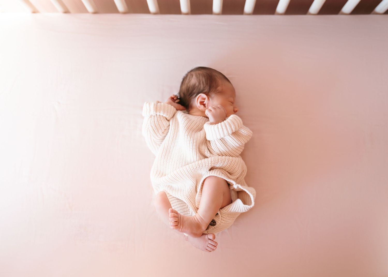 Newborn baby wrapped in soft pink blanket lying on pink background in progressive sequence of poses.