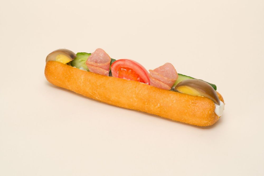 A hot dog with toppings shown in a sequence of five progressive shots from different angles.