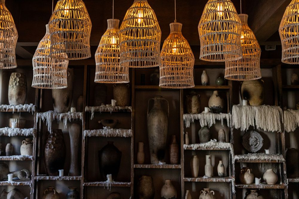 Ilios Cancun restaurant interior decor with warm lighting and textures.