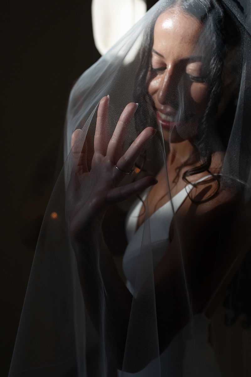 Artistic portrait series showing a figure in white through a dark veil creating a dreamy, ethereal effect.