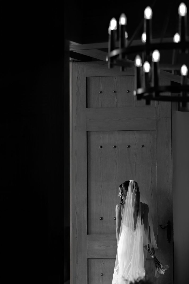 Bride portrait by wooden door at Ilios Cancun.