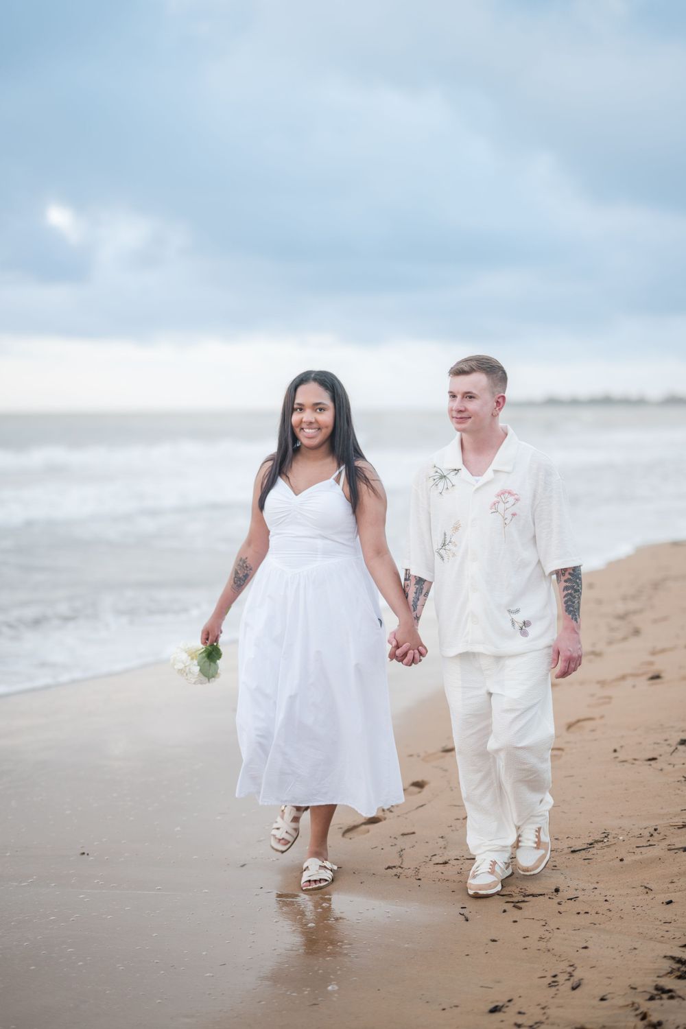 Couple walking together on beach during engagement session at Wyndham Grand Rio Mar Puerto Rico