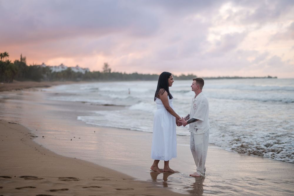 Couple holding hands and walking along shoreline during engagement photos in Rio Grande Puerto Rico
