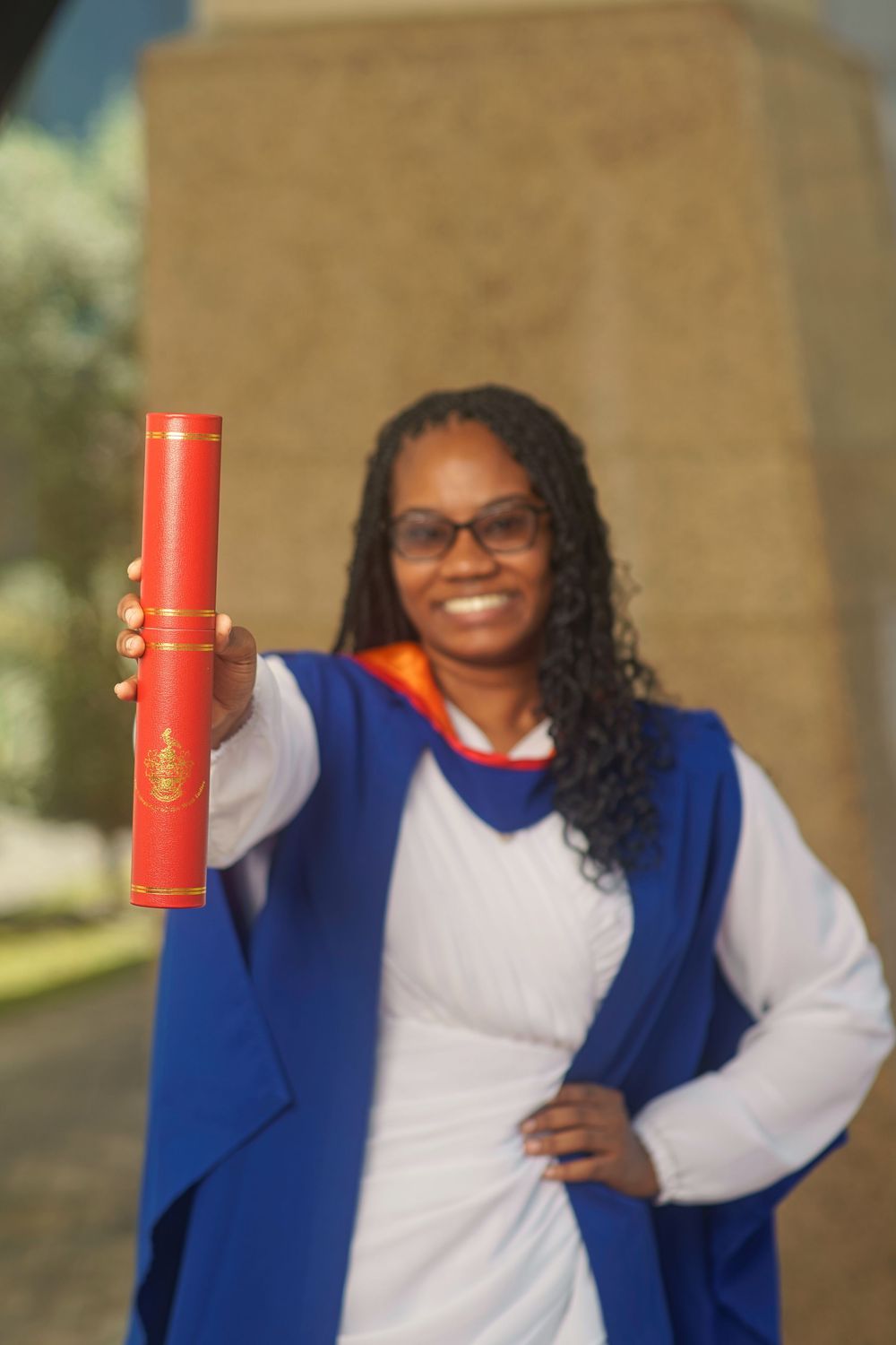 A person in a blue vest and white shirt holds up a red cylindrical container in a series of similar poses.
