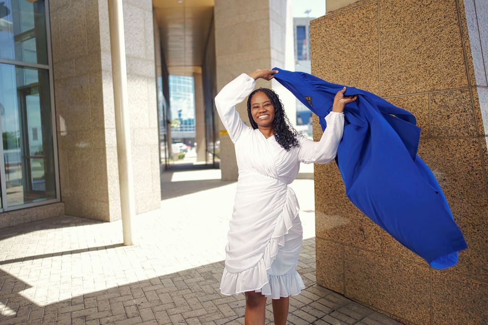 A series of connected images showing someone in a white dress and blue graduation gown posing joyfully outdoors.