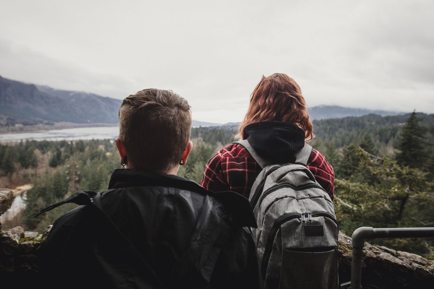 Brianna and Carly look out over the Columbia River Gorge from Beacon Rock on their elopement day. .