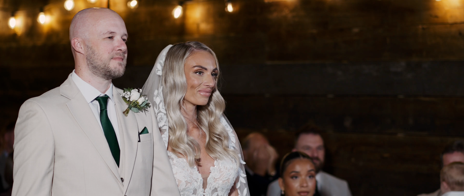 Wedding celebration in a rustic barn venue with string lights creating a warm ambiance.