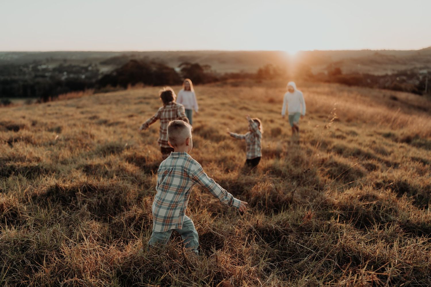 Family playing together in a field in Picton NSW