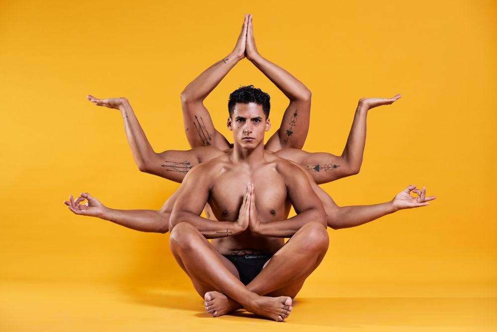 Creative multiple exposure photo showing meditation pose against yellow background.