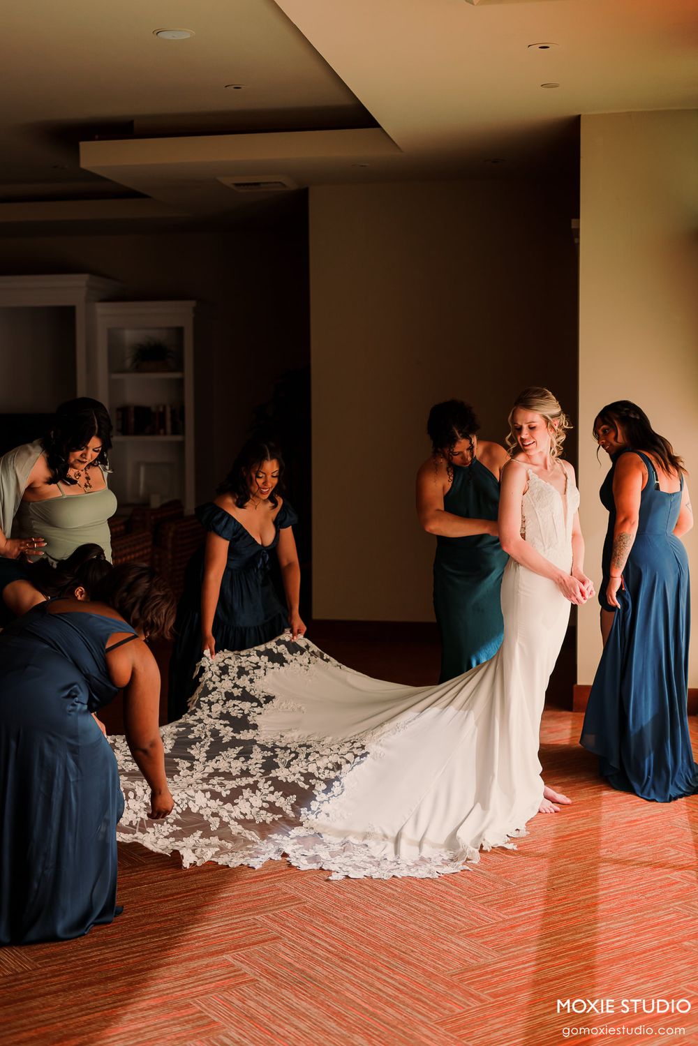 A sequence of wedding preparation photos showing bridesmaids in blue dresses helping with a flowing white wedding gown train.