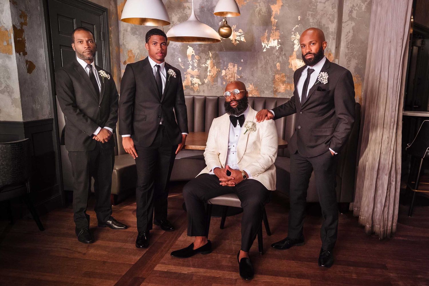 Groomsmen portrait in The Irving tavern at Lenox Hotel Boston with dramatic lighting and editorial style