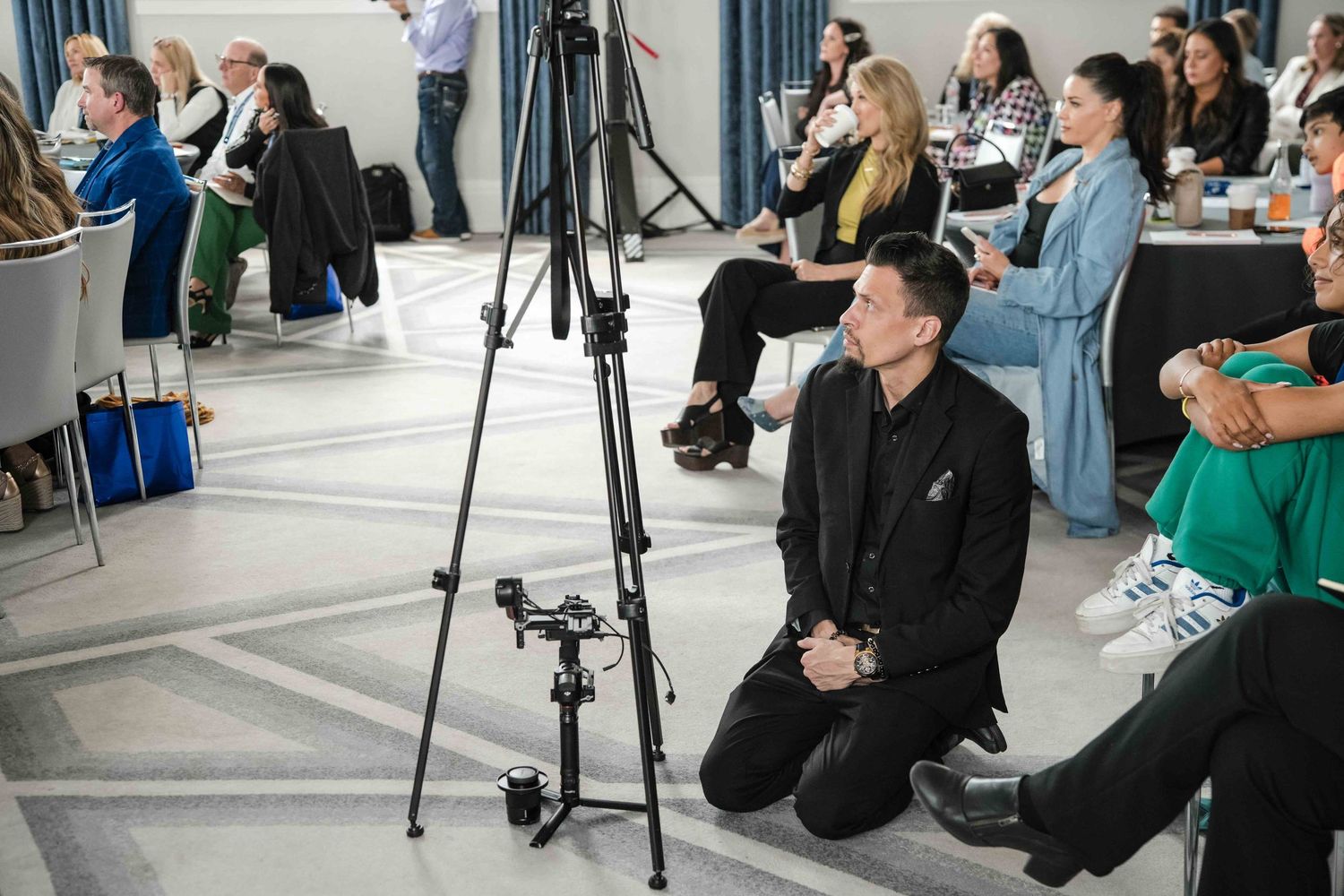 Chicago videographer Nate Templeton kneeing on the floor while monitoring a camera for a promotional video