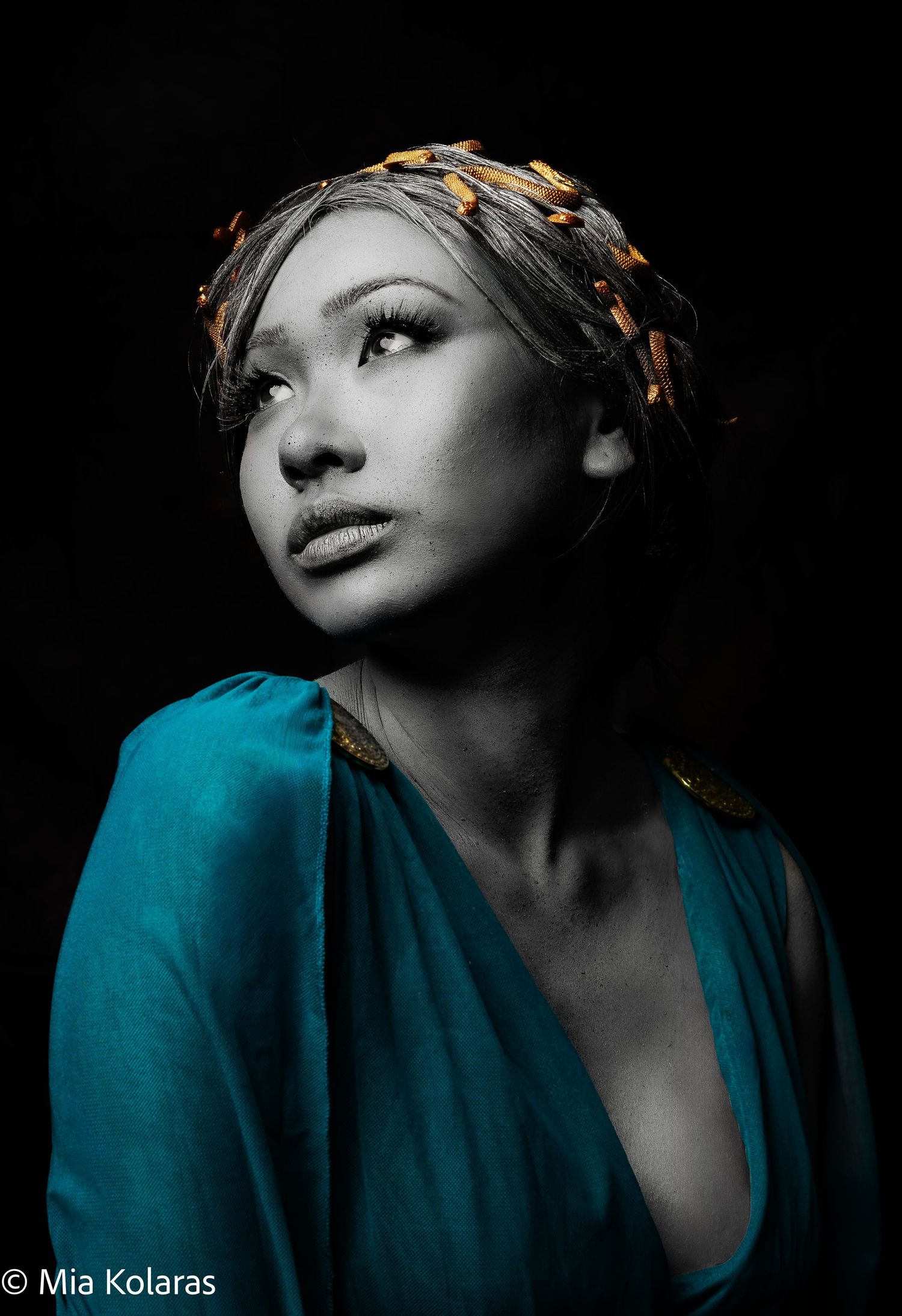 Medusa, girl fully painted in grey paint with golden snakes, looking up and to the left