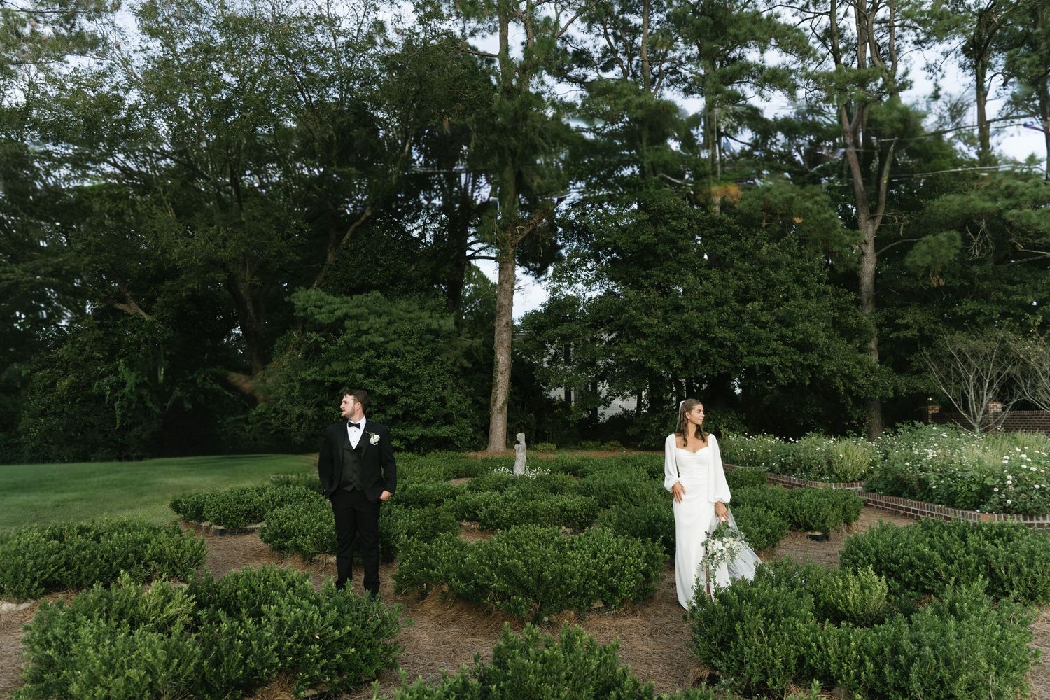 A series of scenic garden path views through lush green landscaping and trees in a tranquil park setting.