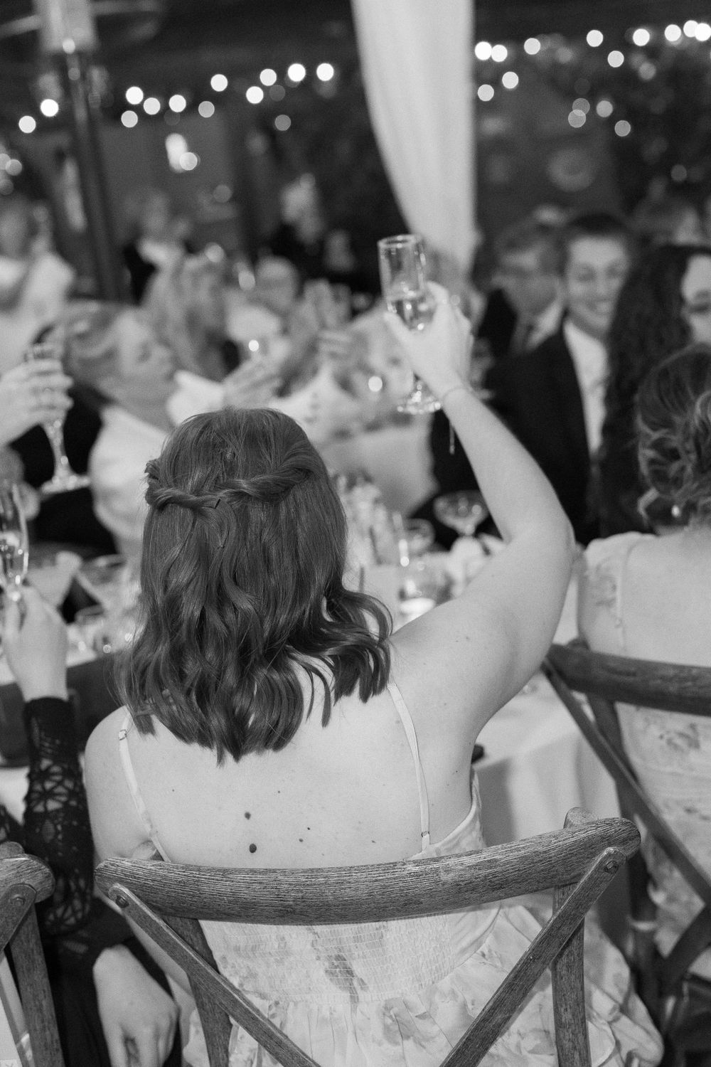 bride holds up champagne glass at los angeles wedding reception