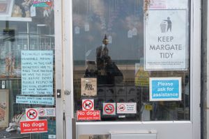 sign in shop window at the end of the covid pandemic