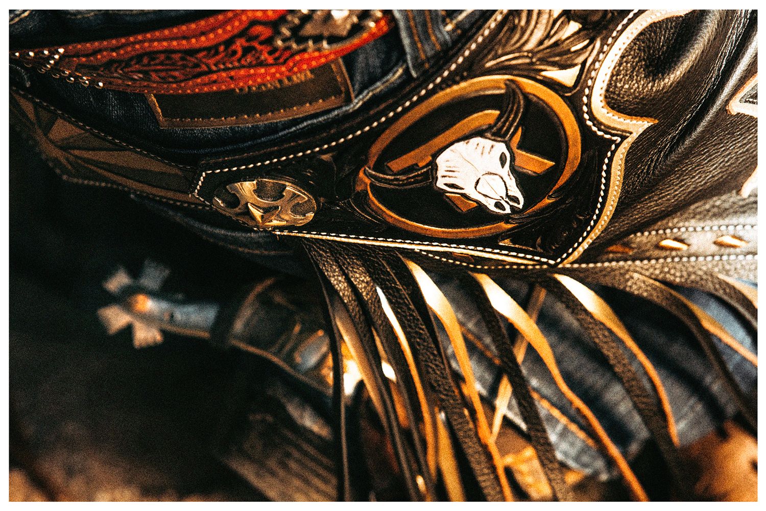 Close-up detail of a black leather rodeo chaps by Sterling Lamb photographed by Chris Douglas for Arizona Ridge Riders PBR Team