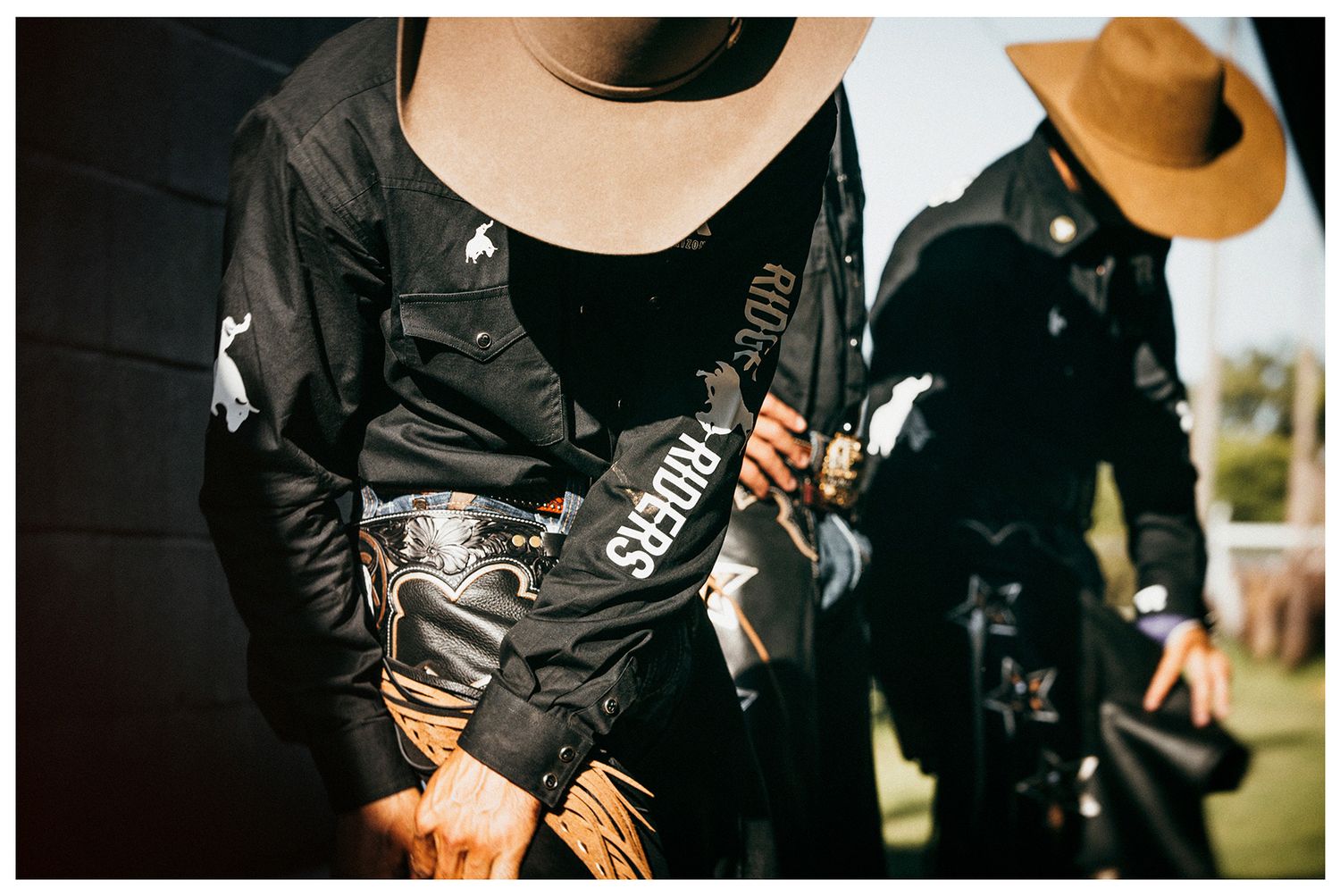 Professional bull riders from Arizona Ridge Riders putting on gear before they ride photographed by Chris Douglas