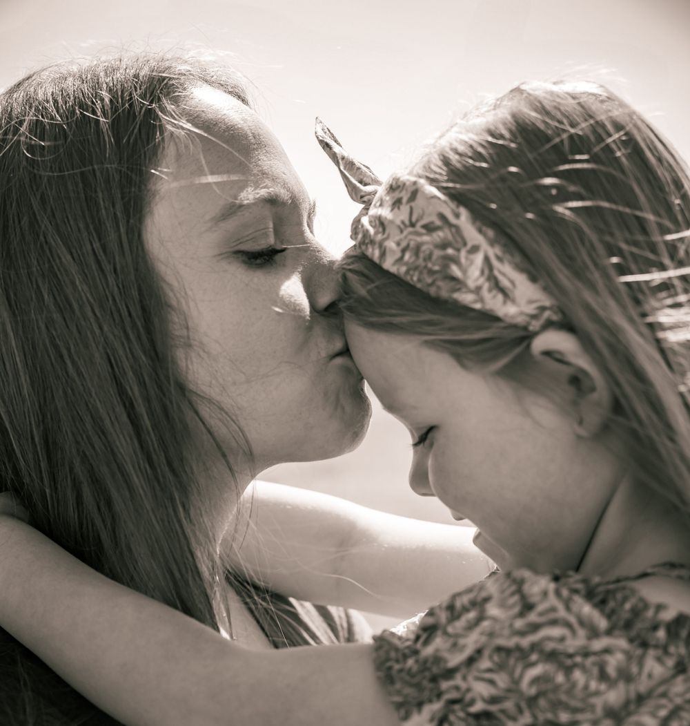 A tender moment of affection and connection captured in black and white photography.