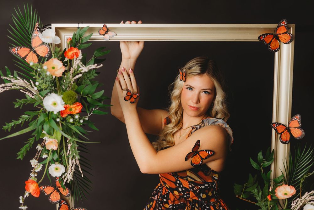Artistic boudoir setup with butterfly motif and natural floral arrangements.