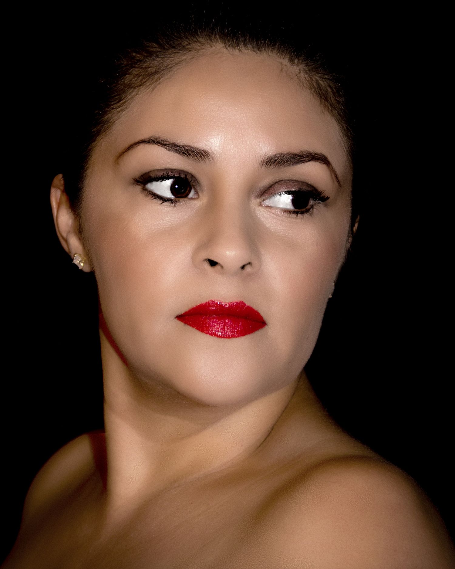 Close-up portrait series showing red lips and dramatic shadows against a black background.