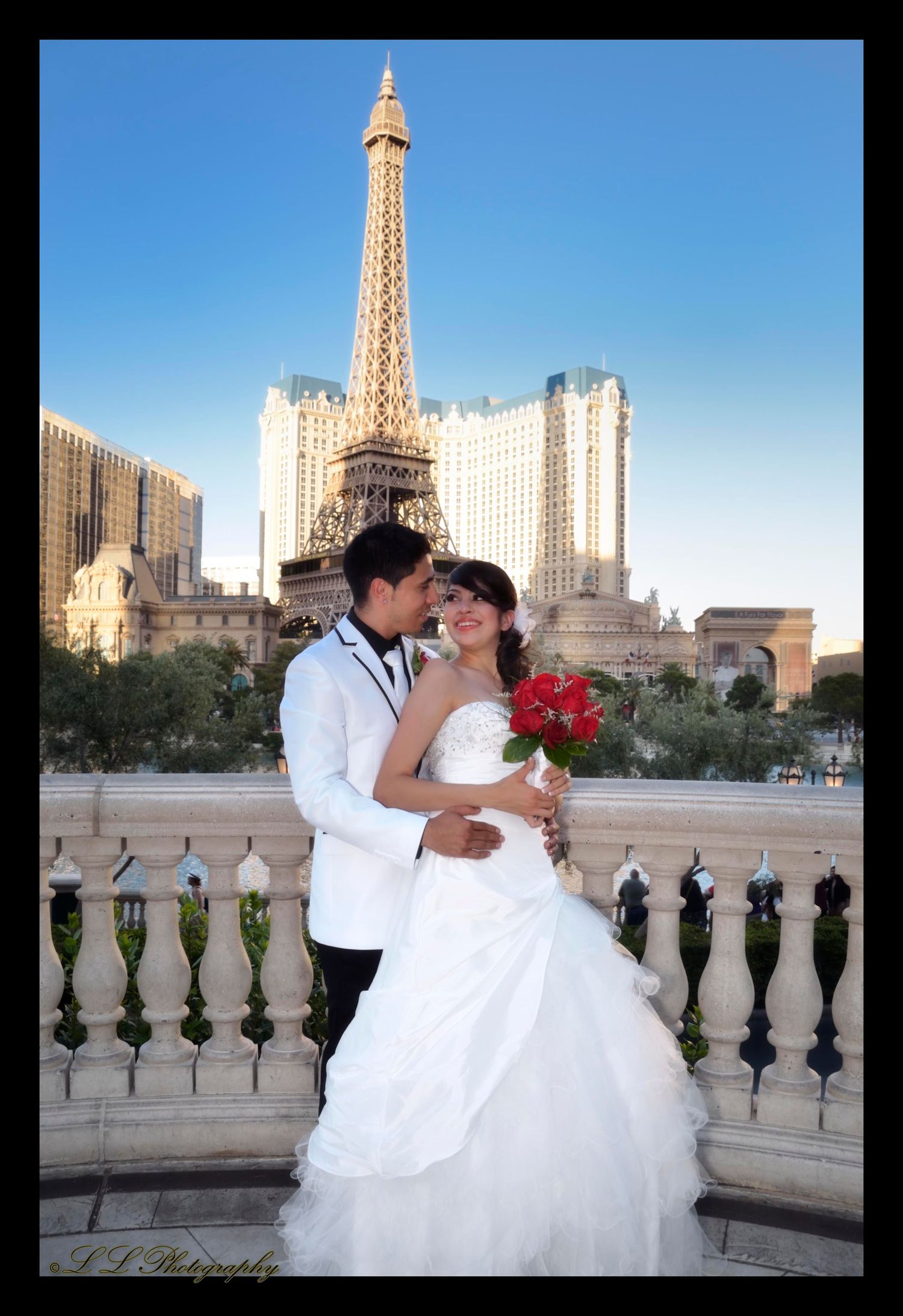 Newlyweds share romantic moments at sunset with the Paris Las Vegas hotel and Eiffel Tower in the background.