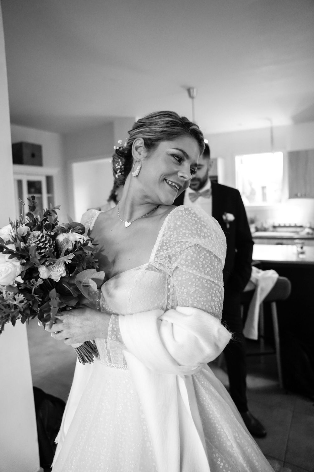 A joyful moment captured in black and white with a beautiful bridal bouquet.